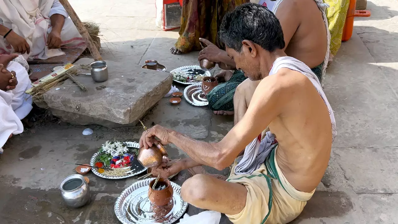A devotee performing asthi visarjan pooja