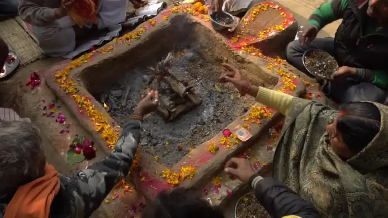 Devotees make their offerings together into the sacred fire