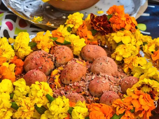 Family member preparing ancestral offerings in Prayagraj